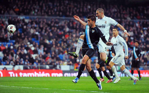 Karim Benzema tucks away Real Madrid's opener in the 7-0 mauling of Malaga (Getty Images)