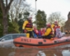 A rescue team helps flood victims in Carlisle