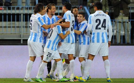Malaga players celebrate