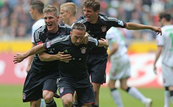Franck Ribery of Bayern celebrates with Bastian Schweinsteiger and Thomas Müller