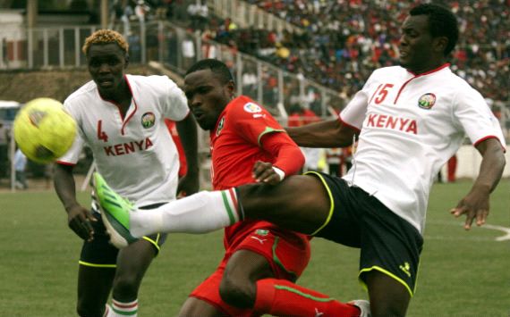 Kenya defenders David Owino and David Ochieng battles a Malawi opponent