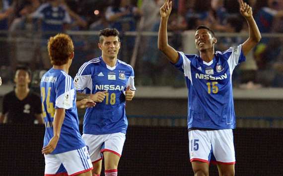 Yokohama F. Marinos defender Yuta Narawa and striker Marquinhos celebrate defender Fabio's goal