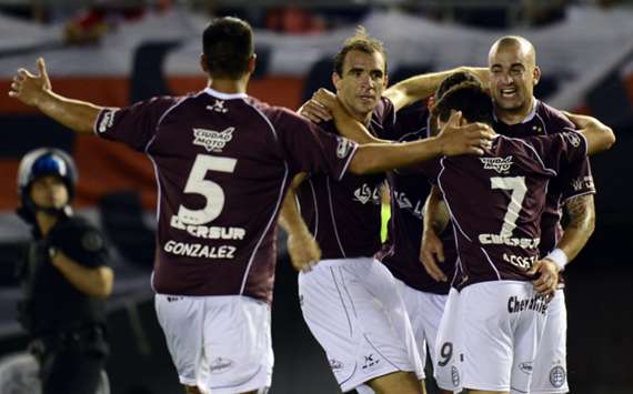 Lanus striker Santiago Silva celebrates with his teammates