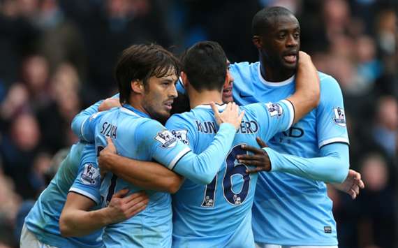Manchester City players celebrate a goal against Arsenal