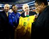 Former Brazillian player, Pele, presents a signed Brazil jersey to former Portugese player Eusebio with Jose Maria Marin, the president of the Brazilian Football Confederation