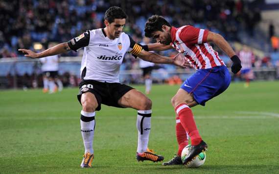 Atletico Madrid and Valencia players battle