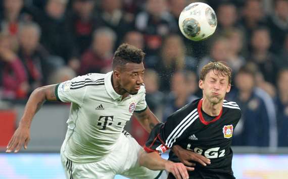 Stefan Kiessling (R) competes with Bayern Munich defender Jerome Boateng