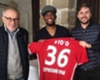 Samuel Eto'o poses with an Amkar Perm shirt