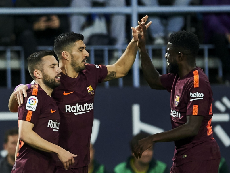 Malaga 0 Barcelona 2: Suarez and Coutinho cheer absent father Messi