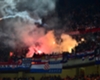 Flares are thrown from the end housing Croatian supporters at San Siro