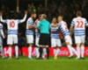 QPR players surround referee Mike Dean