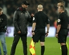 Jurgen Klopp (CL) speaks to Kevin Friend (C) and his assistants