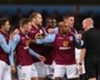 Aston Villa's players confront referee Lee Mason